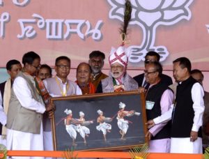 IMPHAL, FEB 25 (UNI)- Prime Minister Narendra Modi being presented a memento at an election rally for the Manipur Assembly polls in Imphal on Saturday. UNI PHOTO-68U